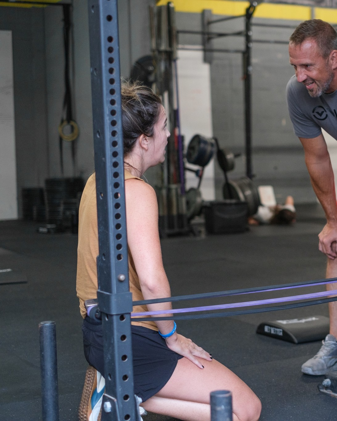 RNF coach guiding a member through a resistance-band stretch during a one-on-one personal training session