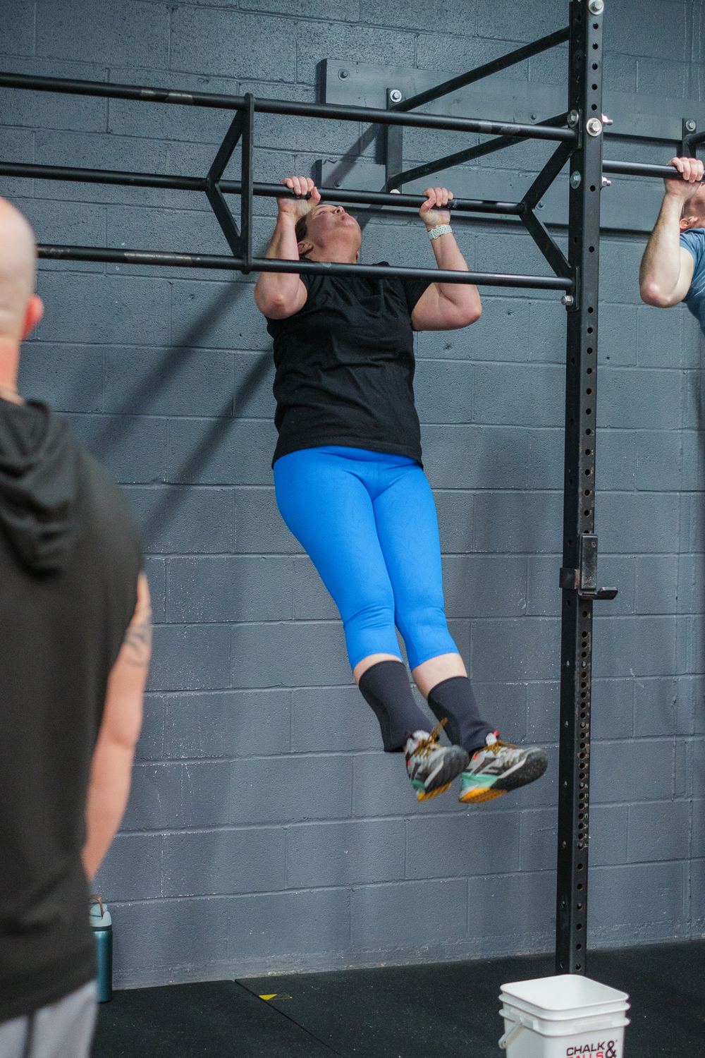 RNF coach watching a member's pull-up during class